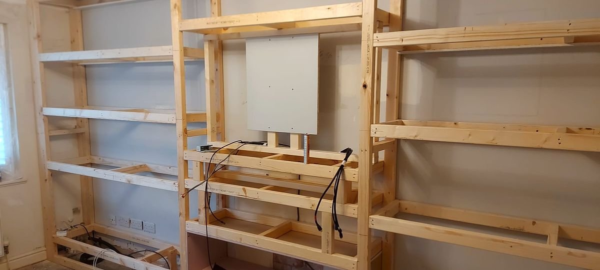 Timber frame of a media wall under construction with cabling in place Timber frame of a media wall under construction with cabling in place