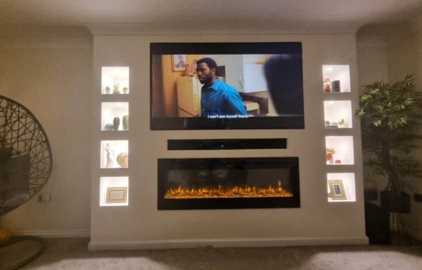 A custom designed and fitted media wall with integrated fireplace and lighting. Cube shelving and cable management.