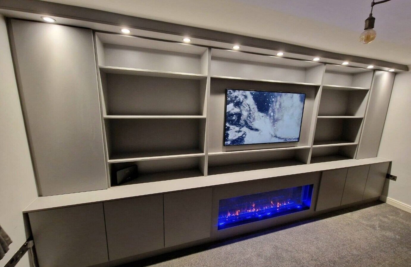 Media wall with fireplace in Warrington with a recessed TV and an inset electric fire